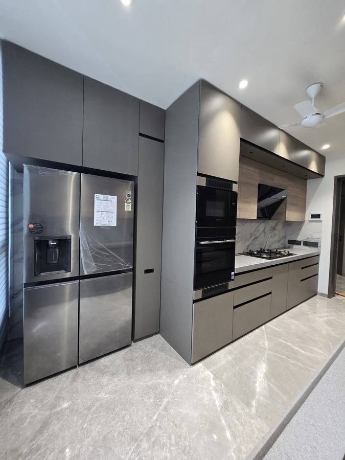 Grey kitchen with integrated stainless steel refrigerator and marble backsplash