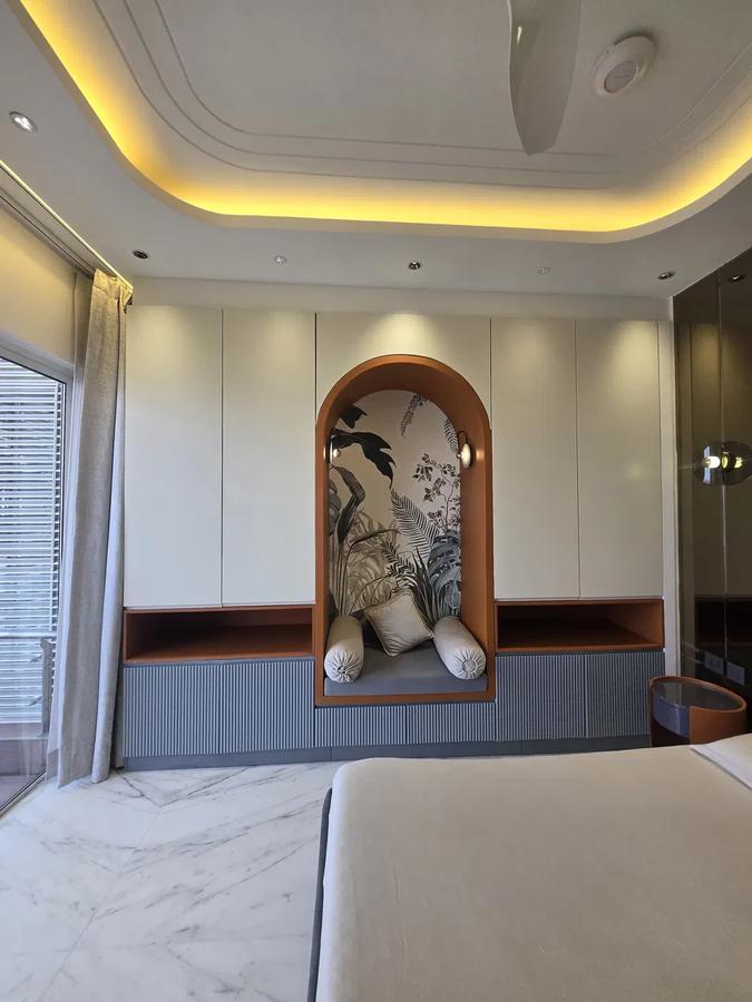 Built-in wardrobes flanking a styled arched reading nook