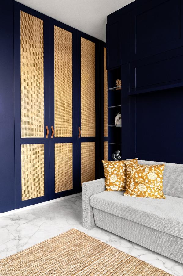 Navy blue wardrobe with woven cane door panels