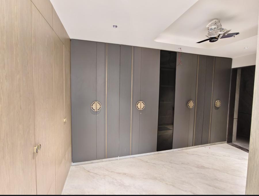 Charcoal wardrobe with fluted inlay and brass circular handles