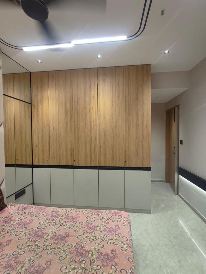 Light oak wardrobe with mirrored panel in styled bedroom