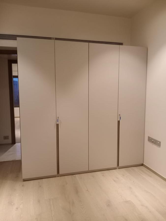 Minimal off-white wardrobe with slim vertical handles